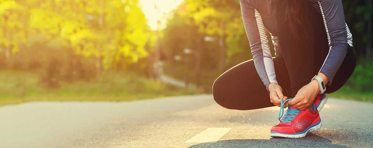 46209273 - female runner tying her shoes preparing for a run a jog outside