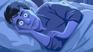 Man ligt in bed en kan niet slapen